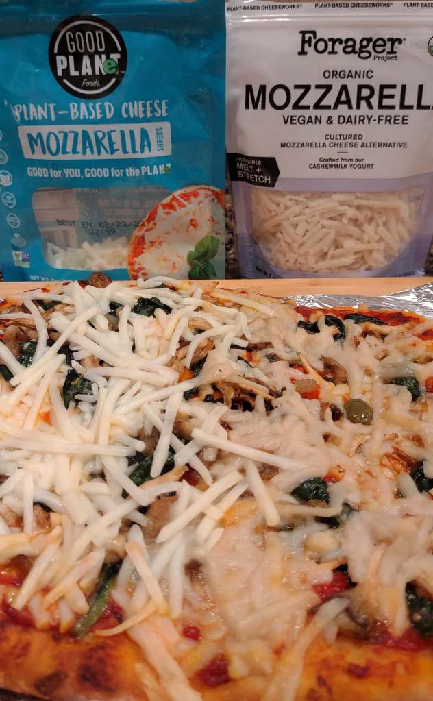 Comparison of two brands of vegan mozzarella on a homemade pizza – Good Planet and Forager. The photo shows that the Good Planet cheese hasn't melted as much as the Forager cheese. Good Planet cheese – sustainability, review.