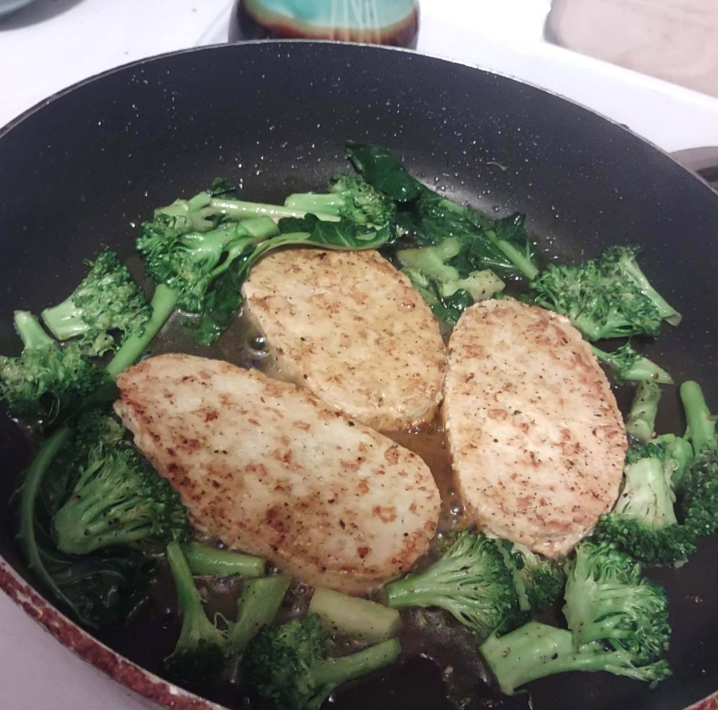 Gardein Chick’n Scallopini being cooked in a non-stick pan along with broccoli florets. Gardein products review & Conagra ethics update. 