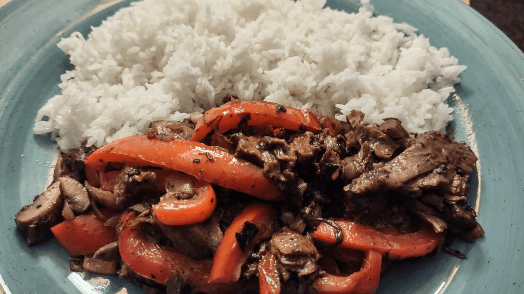 A meal prepared with Beyond Steak, which was cooked with fennel and peppers and served with rice on the side. 